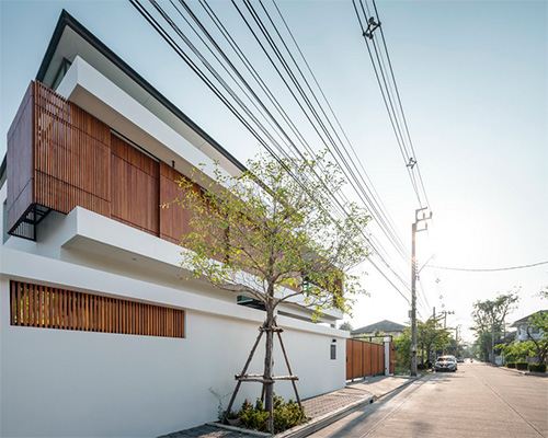 archimontage applies wooden sliding panels to bangkae house in bangkok