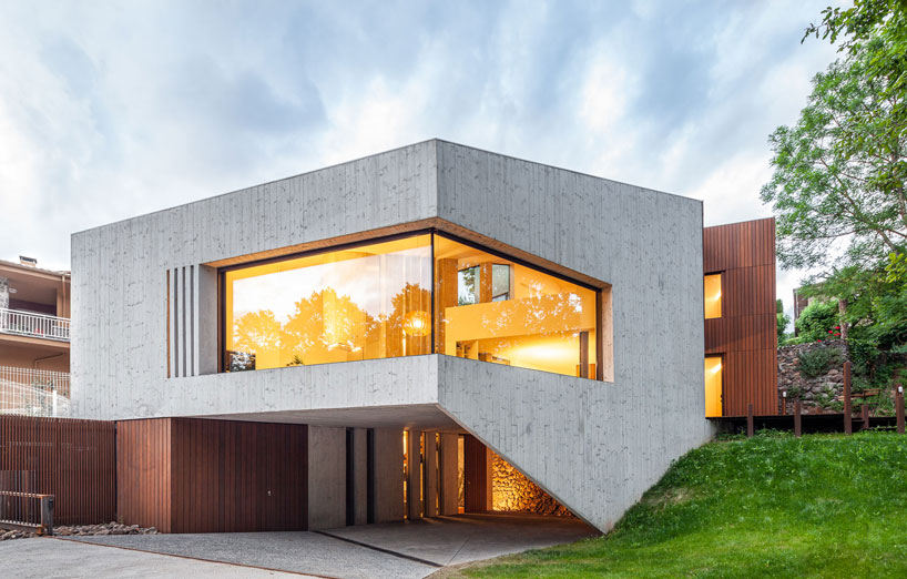 arnau estudi d'arquitectura embeds the 'forest stone' house into a sloped site in spain designboom