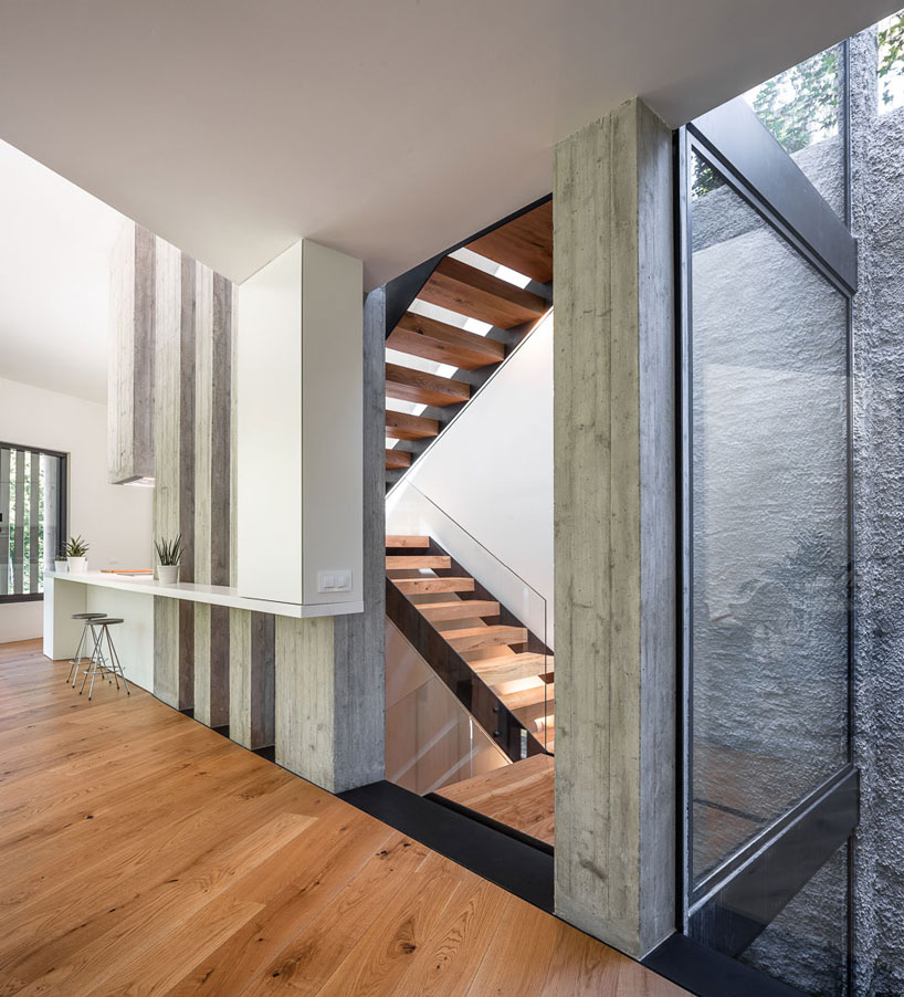 arnau estudi d'arquitectura embeds the 'forest stone' house into a sloped site in spain designboom