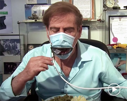 this face mask has a hinged mouth so it can be worn while eating