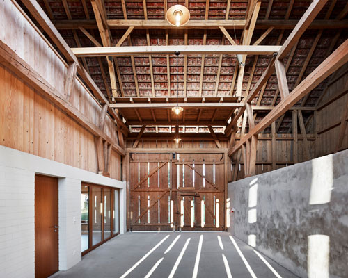 MJ2B architekten turns a former barn into apartments in cordast, switzerland