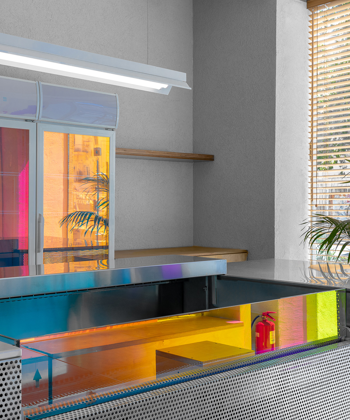 simon barazin uses dichroic glass to create colorful + reflective cafe interior in tel aviv