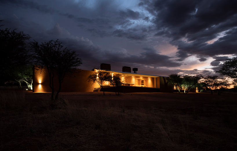 slee & co. architects' red earth game lodge emerges from the namibian landscape