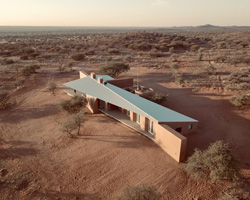 slee & co. architects' red earth game lodge emerges from the namibian landscape