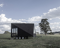 studio edwards puts a sleek, black A-frame cabin on wheels