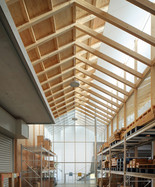 arii irie architects tops light-filled warehouse in ageo, japan, with exposed timber roof truss