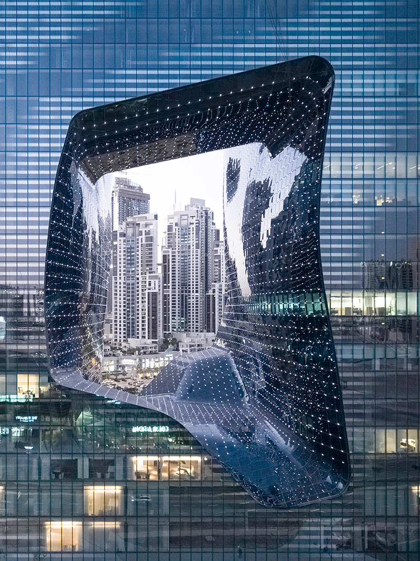 zaha hadid's 'opus' building in dubai photographed by laurian ghinitoiu