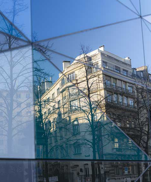 aldric beckmann applies an abstract pattern of colored glass to a parisian boulevard
