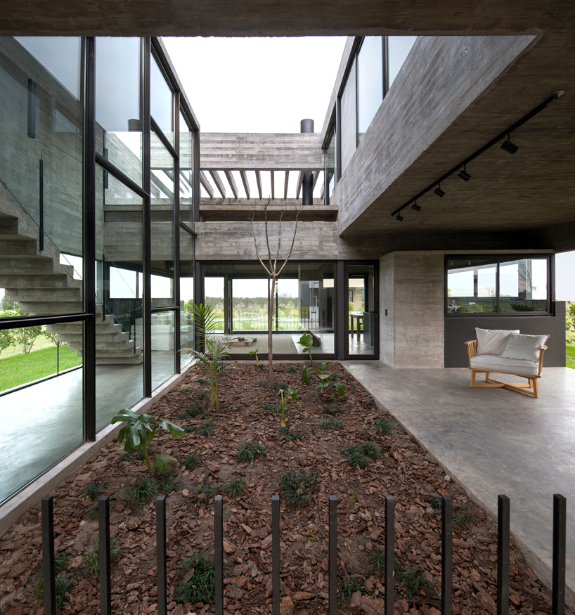 bare concrete volumes + black finishes articulate the castaños house in argentina designboom