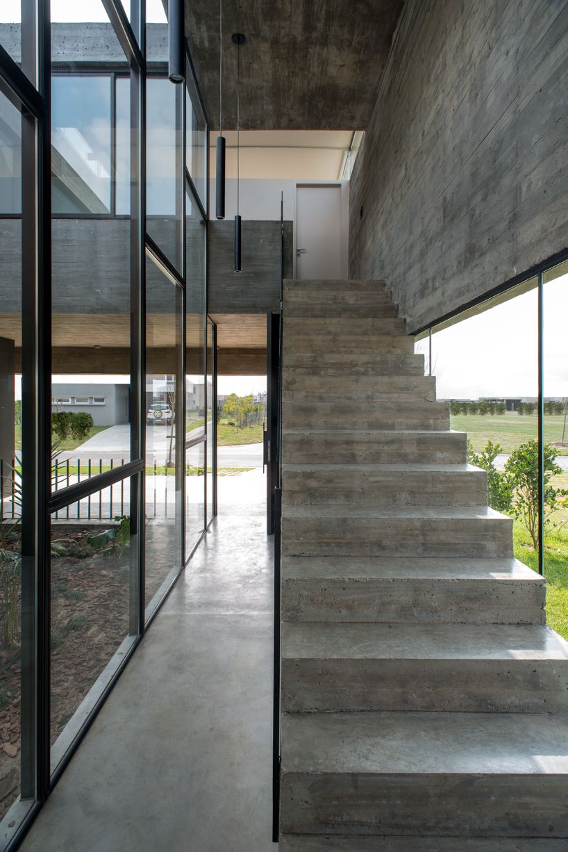 bare concrete volumes + black finishes articulate the castaños house in argentina designboom