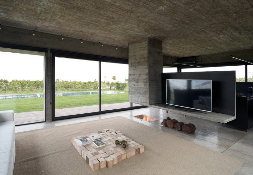 bare concrete volumes + black finishes define castaños house in argentina