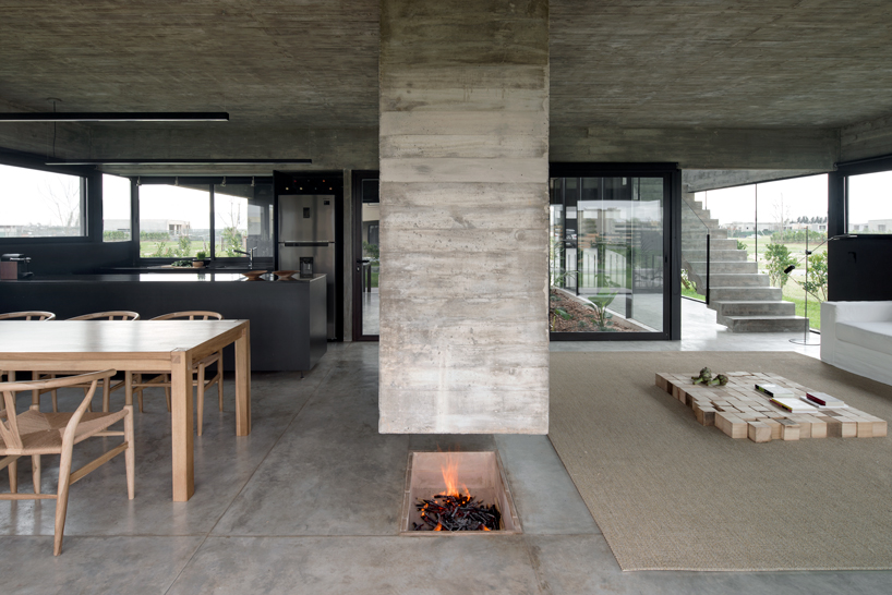 bare concrete volumes + black finishes define castaños house in argentina