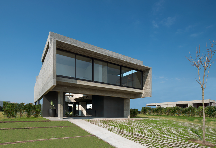 bare concrete volumes + black finishes articulate the castaños house in argentina designboom