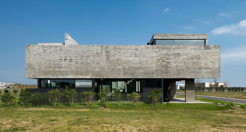 bare concrete volumes + black finishes articulate the castaños house in argentina designboom