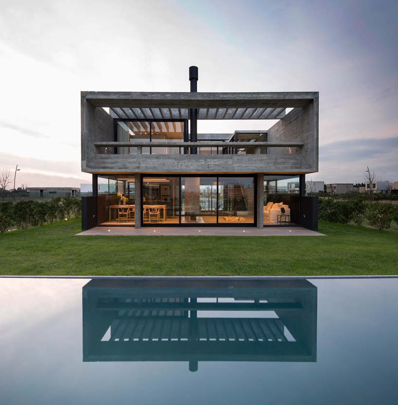bare concrete volumes + black finishes articulate the castaños house in argentina designboom