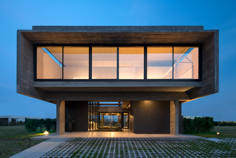 bare concrete volumes + black finishes articulate the castaños house in argentina designboom