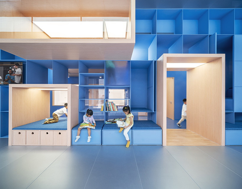 crossboundaries organizes Qkids education space in china around a 'blue spine'