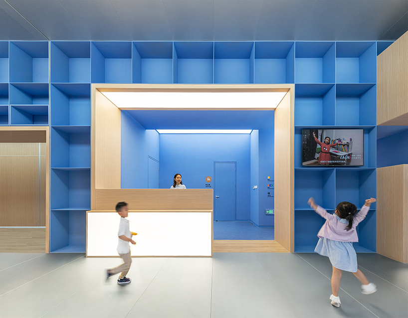 crossboundaries organizes Qkids education space in china around a 'blue spine'