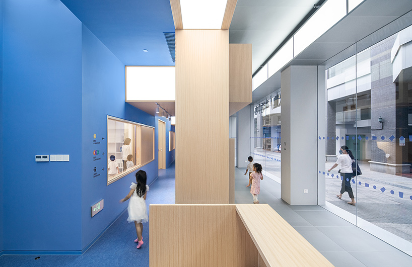 crossboundaries organizes Qkids education space in china around a 'blue spine'