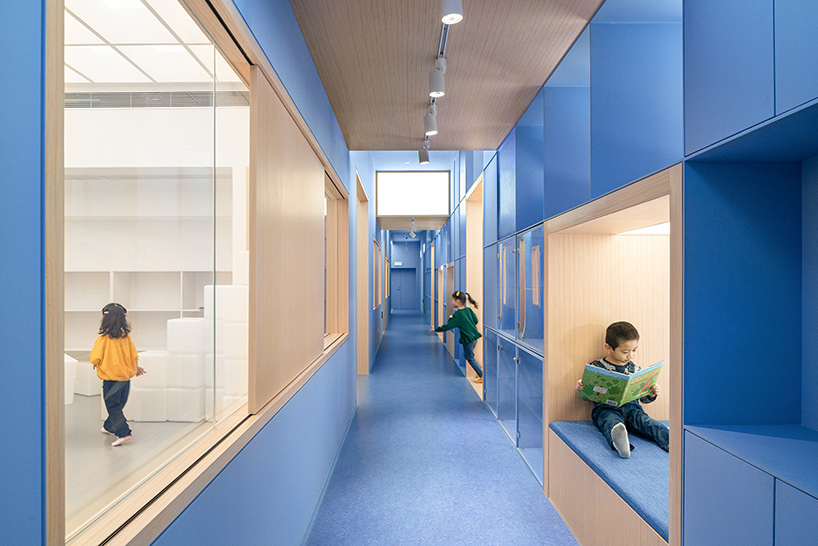 crossboundaries organizes Qkids education space in china around a 'blue spine'