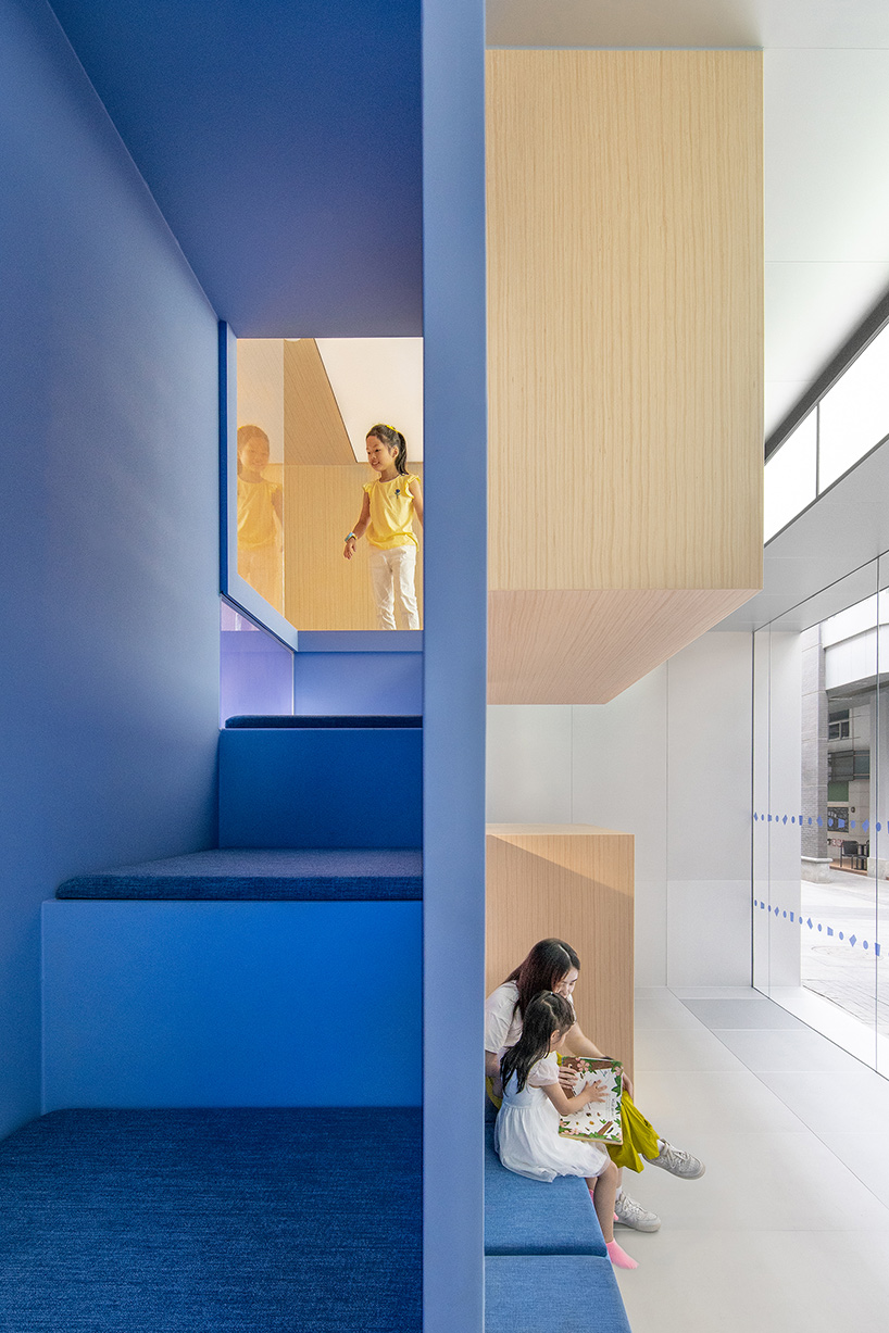 crossboundaries organizes Qkids education space in china around a 'blue spine'