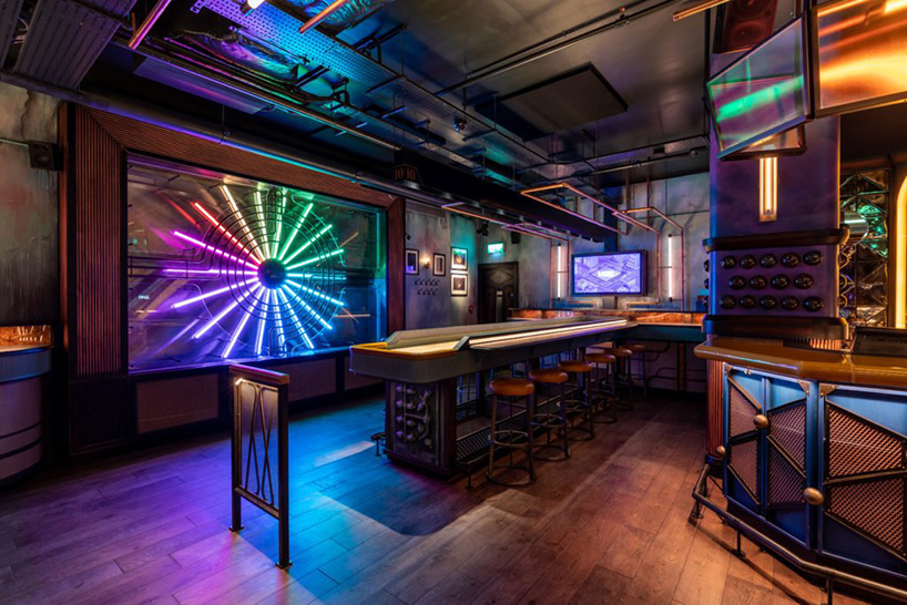 ellis design studio adds art deco elements within industrial, electric bar  interior in london