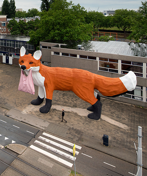 florentijn hofman's gigantic fox wanders through the grey streets of rotterdam
