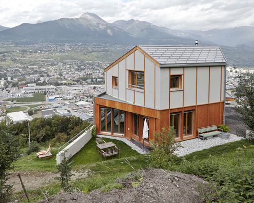holzhausen zweifel nestles contemporary swiss 'maison broccard' along alpine slope