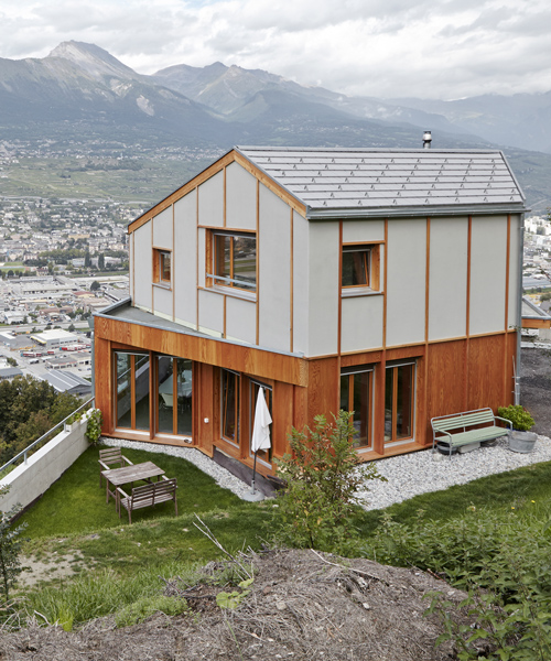 holzhausen zweifel nestles contemporary swiss 'maison broccard' along alpine slope