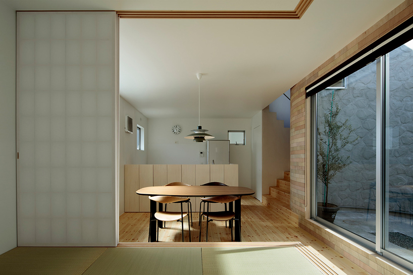 house + dance studio by international royal architecture wraps around open garden in japan
