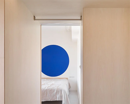 ST design studio adds central plywood shelf installation within minimal residence in taiwan