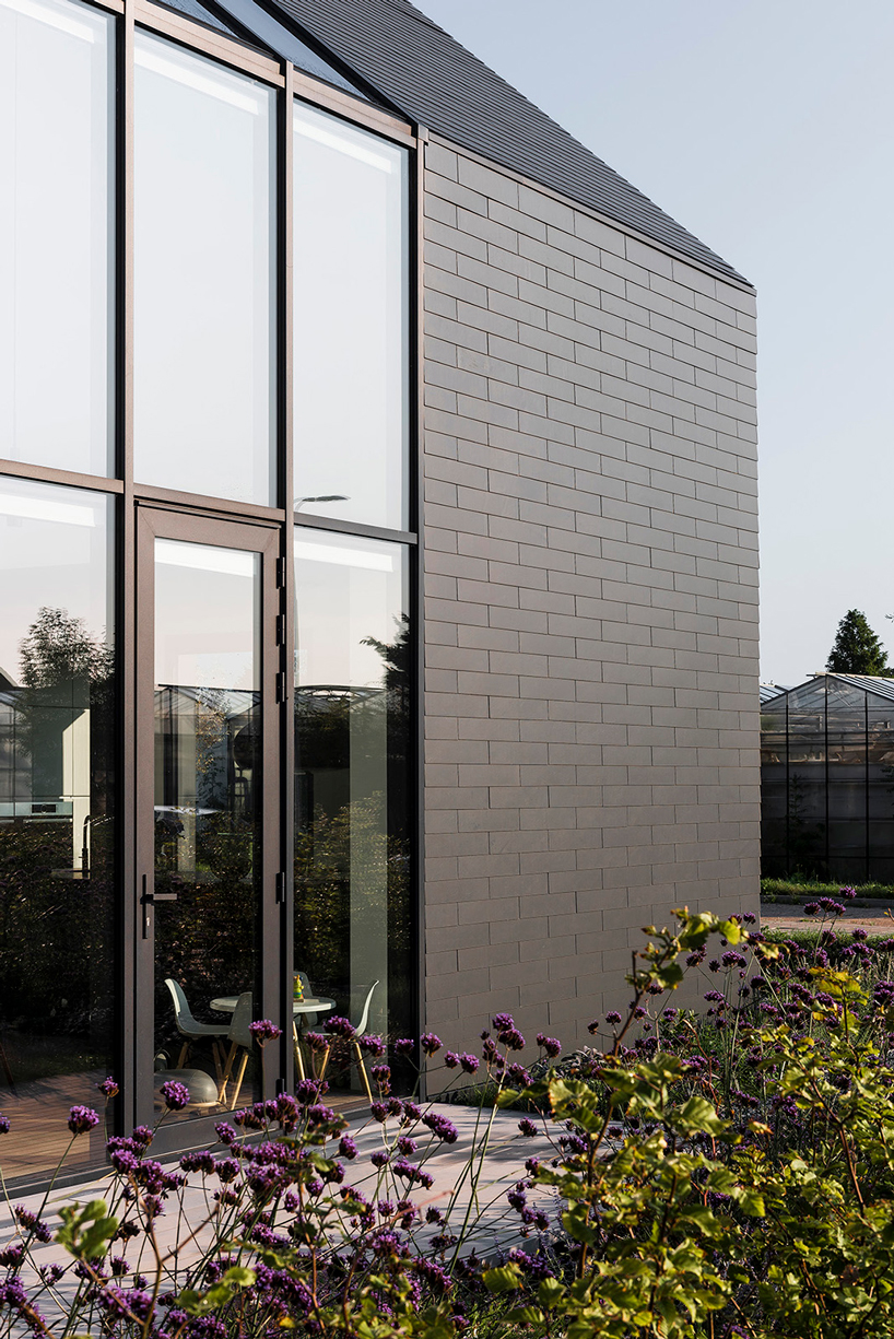 Timber-clad extension reconnects post-war Dutch residence with nature