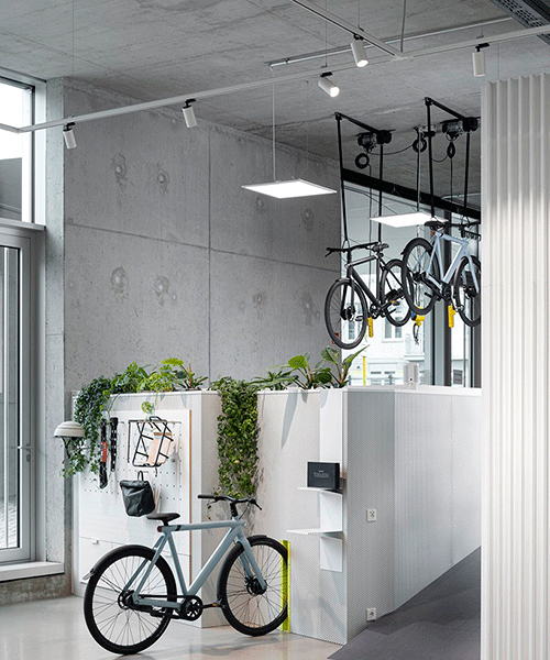 concrete walls + steel counters complete urban bike store interior by ninetynine in berlin