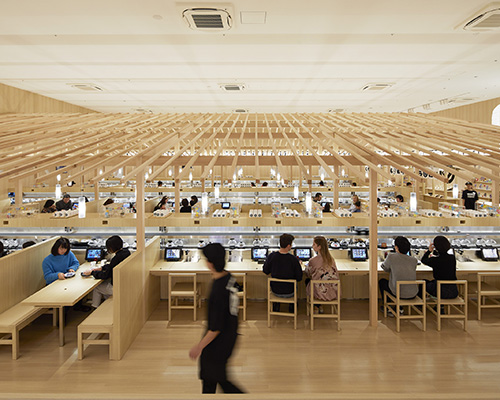 kashiwa sato inserts wood-gabled structure inside kura sushi flagship in tokyo