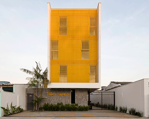 laurent troost adds bright yellow metal lattice facade to apartment complex building in brazil