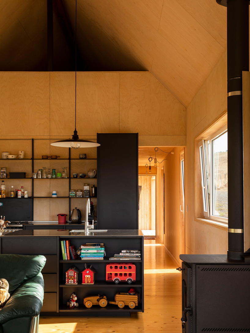 inside, MAKE architects has finished the house with timber floors and fully lined ply walls and ceiling