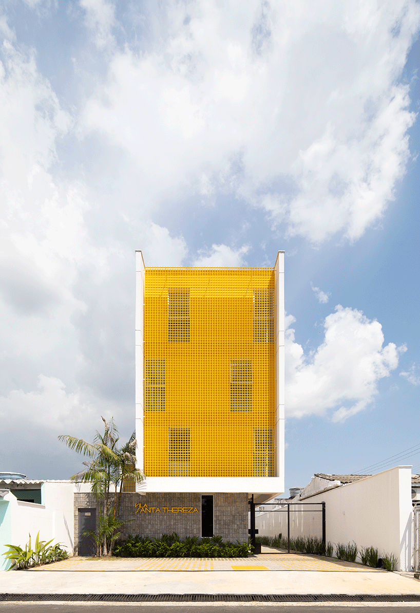 laurent troost adds bright yellow metal lattice facade to apartment complex building in brazil