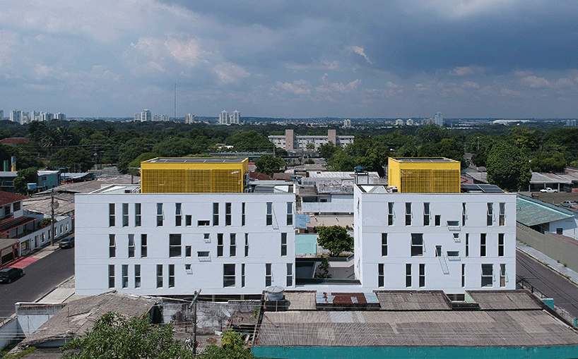 laurent troost adds bright yellow metal lattice facade to apartment complex building in brazil