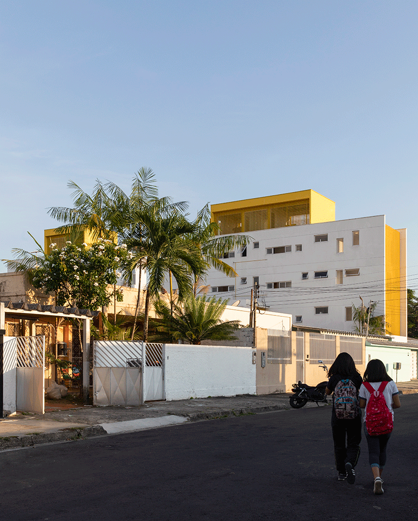 laurent troost adds bright yellow metal lattice facade to apartment complex building in brazil