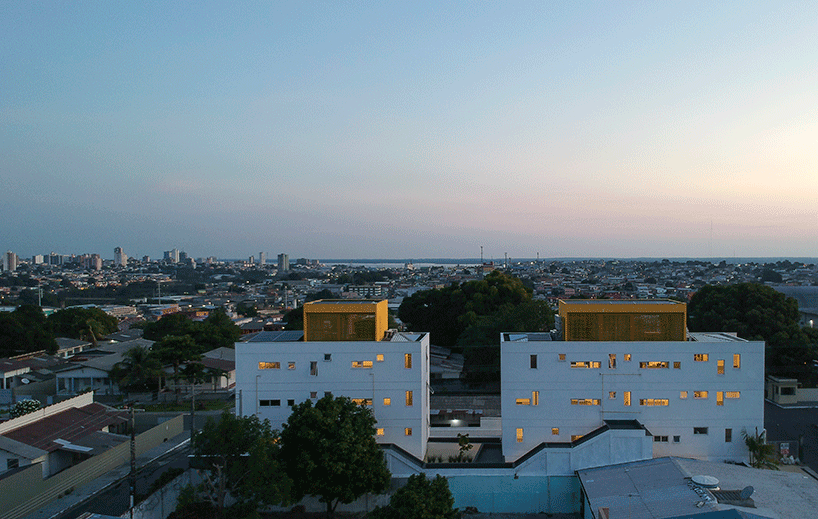 laurent troost adds bright yellow metal lattice facade to apartment complex building in brazil