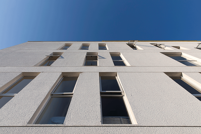 laurent troost adds bright yellow metal lattice facade to apartment complex building in brazil