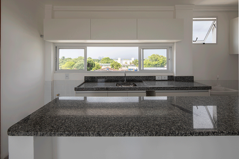 laurent troost adds bright yellow metal lattice facade to apartment complex building in brazil
