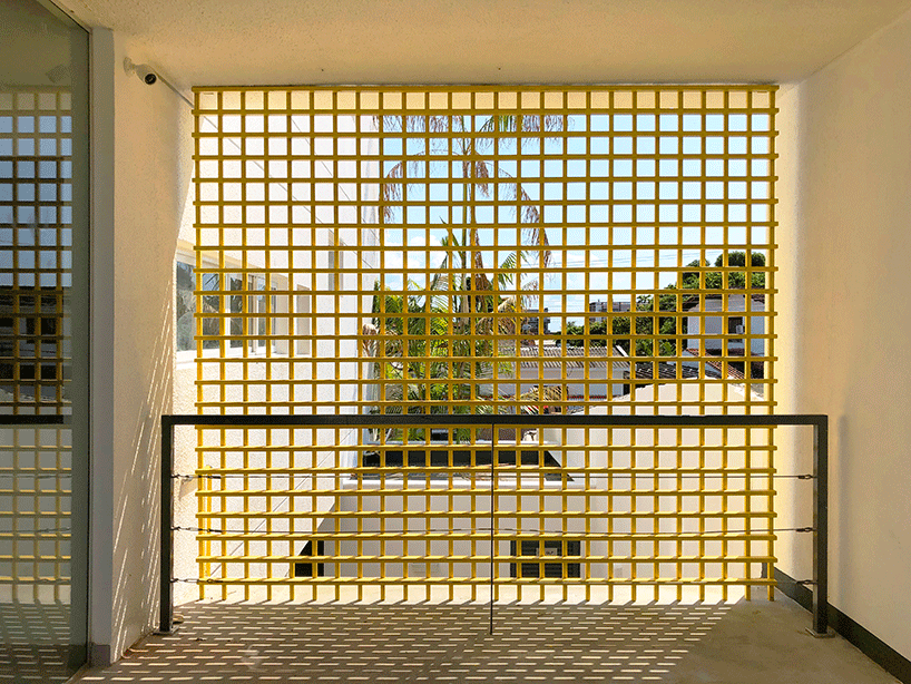laurent troost adds bright yellow metal lattice facade to apartment complex building in brazil