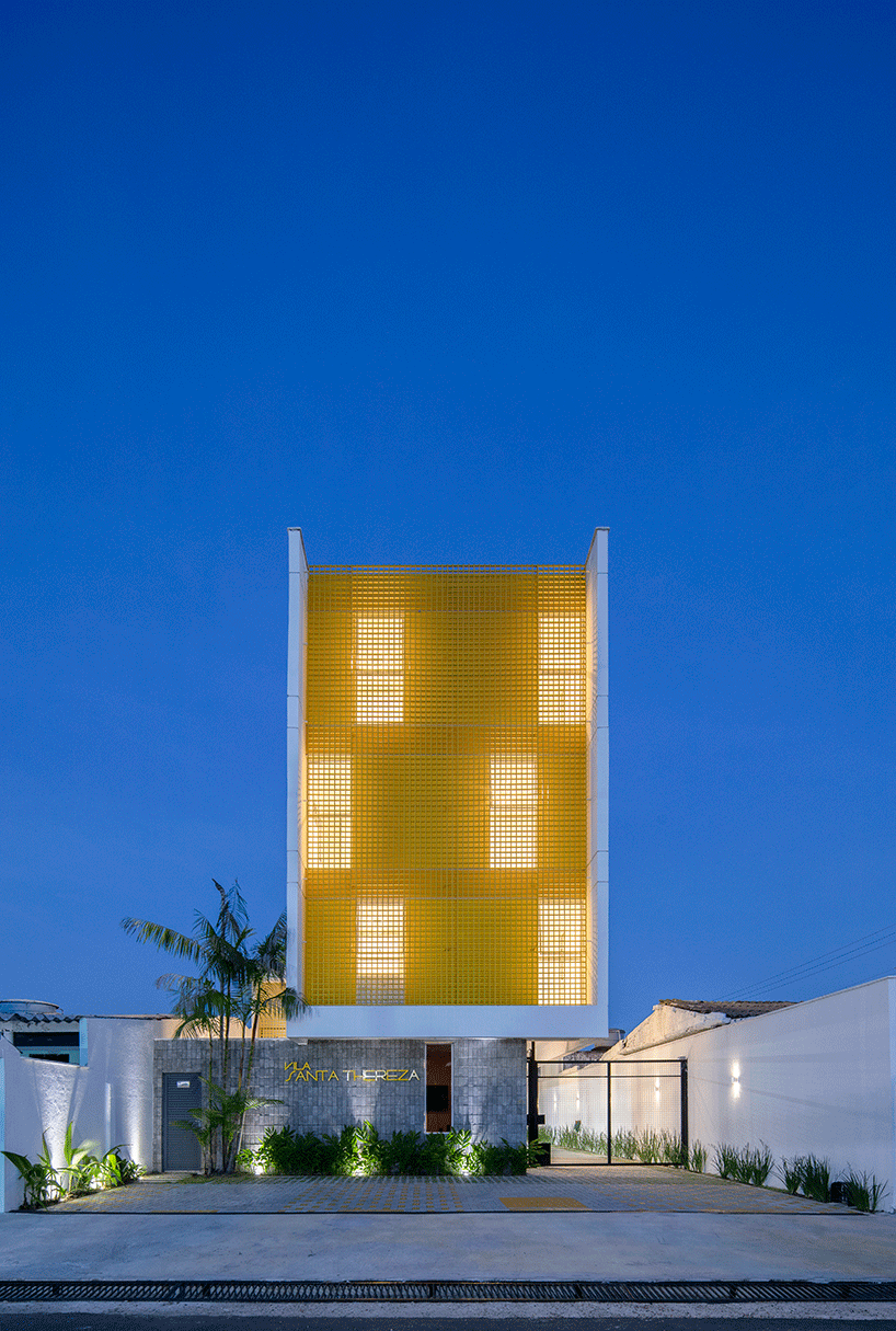 laurent troost adds bright yellow metal lattice facade to apartment complex building in brazil