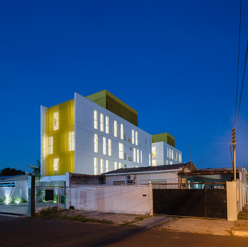 laurent troost adds bright yellow metal lattice facade to apartment complex building in brazil