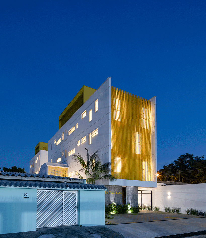 laurent troost adds bright yellow metal lattice facade to apartment complex building in brazil