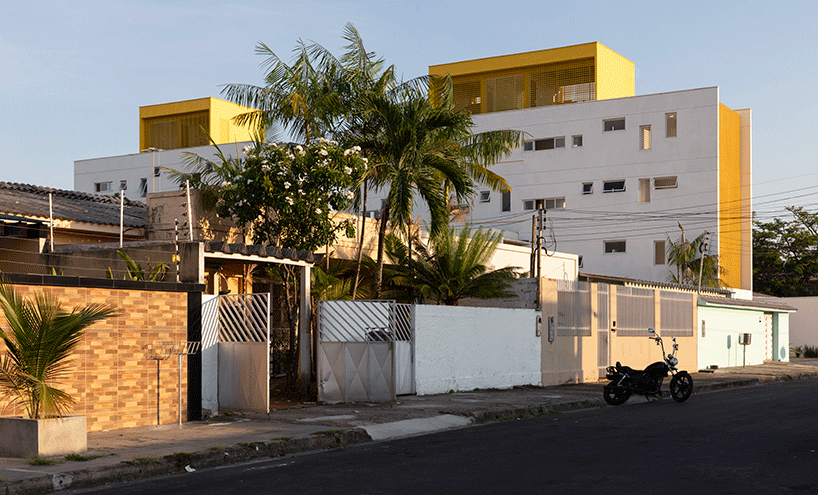 laurent troost adds bright yellow metal lattice facade to apartment complex building in brazil
