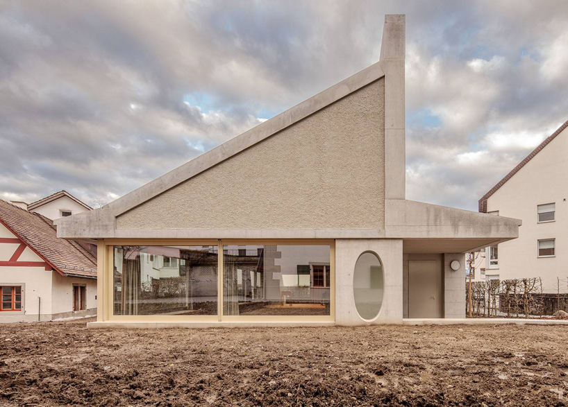 asymmetrical pitched roof tops parish hall by joos & mathys + daniel nyffeler in switzerland