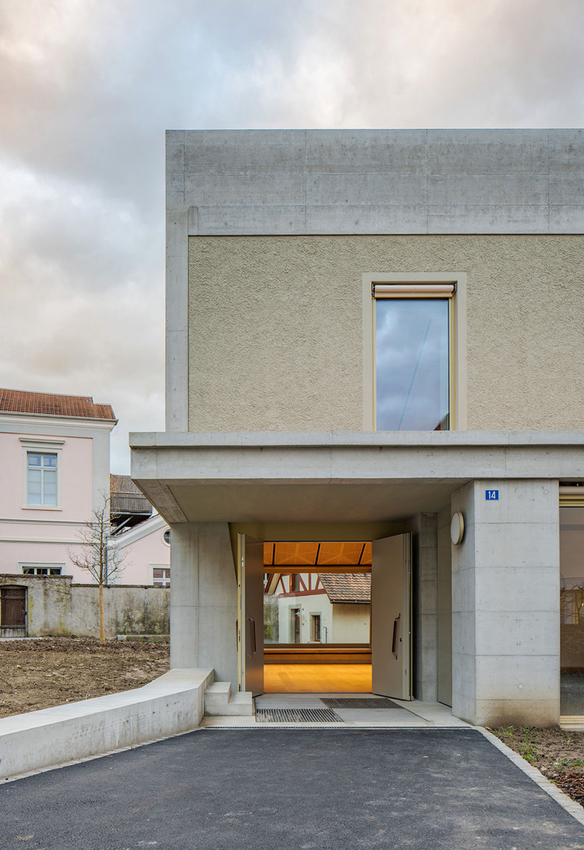 asymmetrical pitched roof tops parish hall by joos & mathys + daniel nyffeler in switzerland