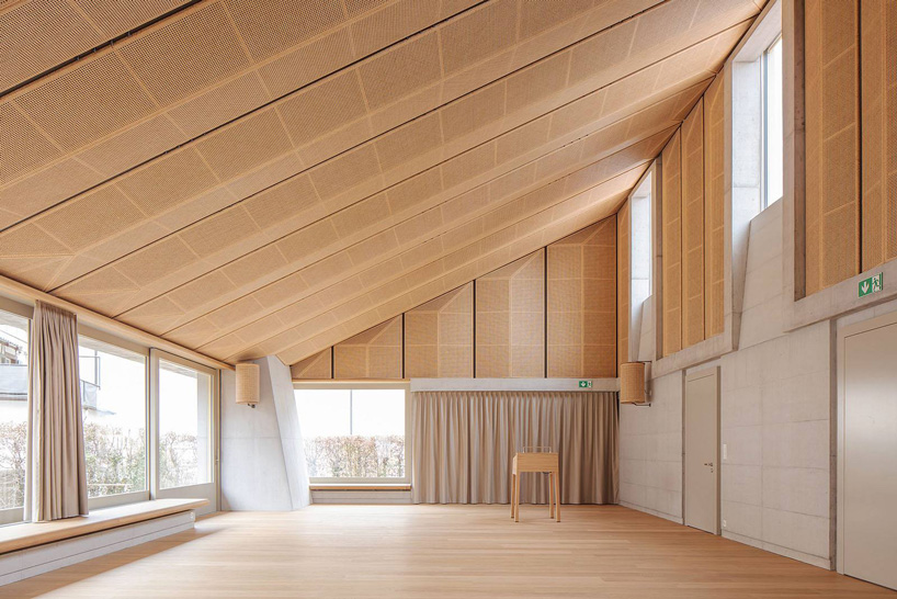 inside, concrete is combined with ceiling panels clad with viennese mesh